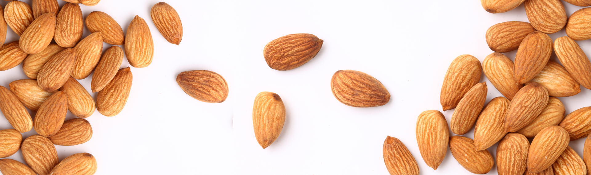 a group of almonds on a white surface